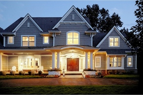 Traditional shingle style home with wide covered porch and shake siding.