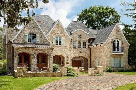 English Manor house with stone exterior and porte-cochere.